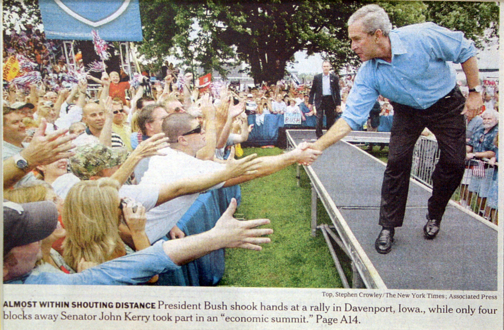 President George W Bush shaking hands at political rally