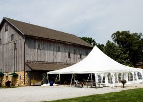 40′ x 40′ Rope and Pole tent next to barn at Sutliff Cider Company