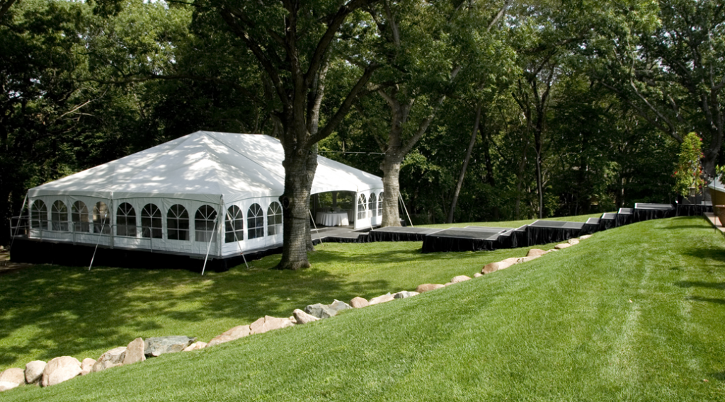 40' x 60' wedding tent on top of level stage with steps up hill