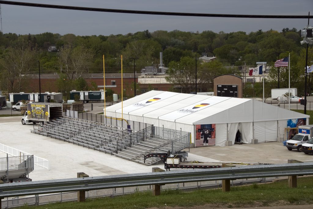 Ashford University graduation ceremony with tents and bleachers