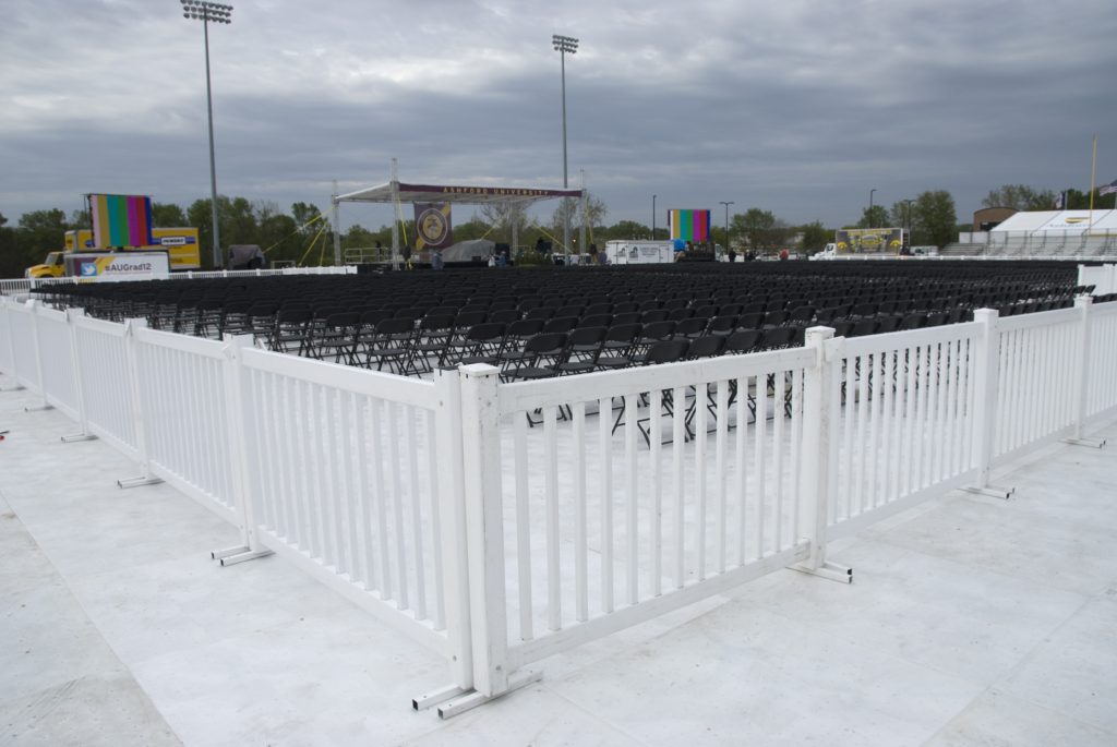 White fence and Black chairs at Ashford University graduation ceremony