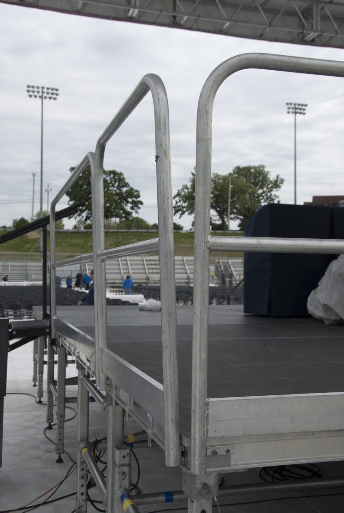 Stage with guard rails at Ashford University graduation ceremony