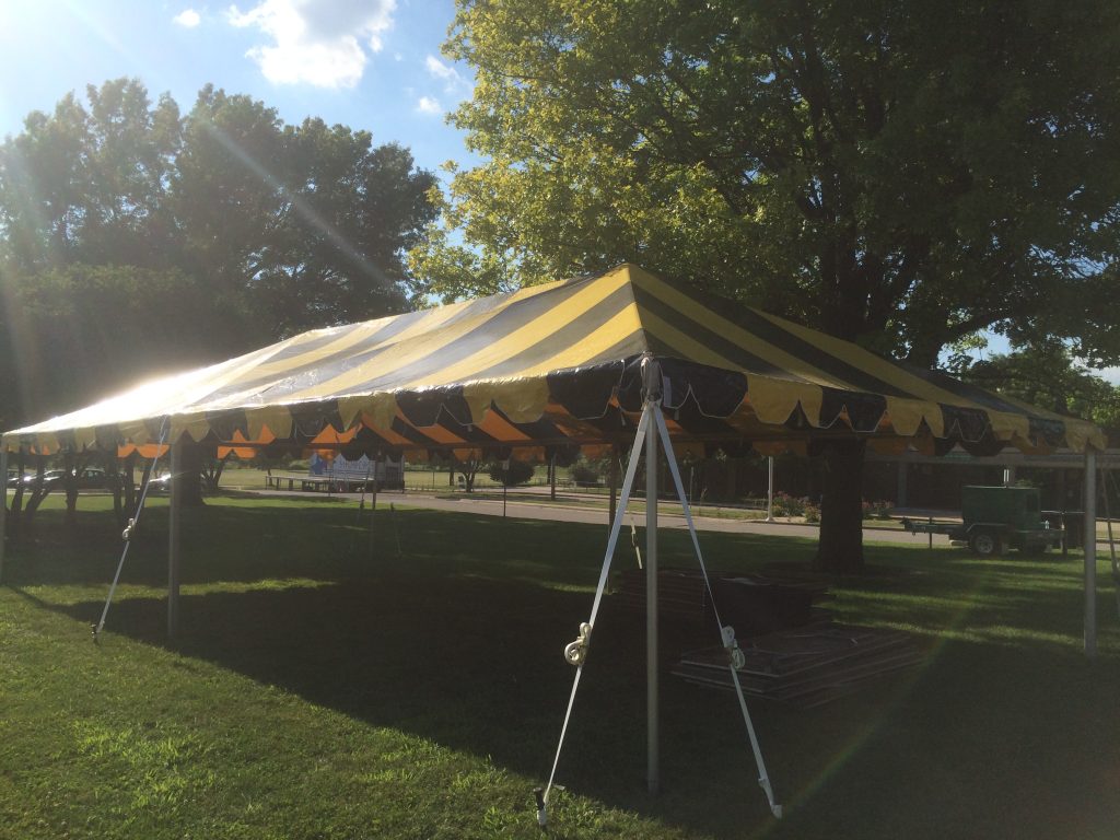 20' x 40' black and yellow frame tent on grass