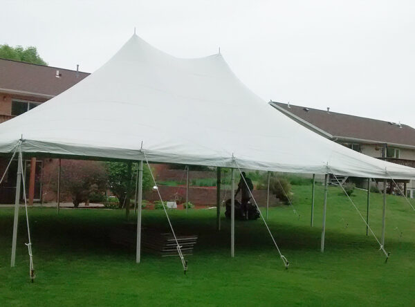 Side view 30' x 40' Rope and Pole tent setup for a backyard high school graduation party. Side view 30' x 40' Rope and Pole tent setup for a backyard high school graduation party.