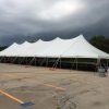 40' x 120' Rope and Pole Tent and a storm coming with a dark sky