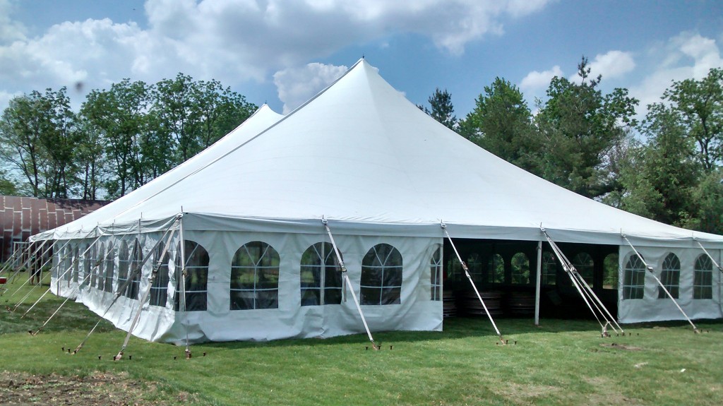 View of 60' x 90' Genesis rope and pole tent in Wedding in Wellman, Iowa. With Frence sidewalls attached.