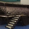 7 Row by 32 feet long granite expandable breakdown bleacher system setup on stage. Elevated for pictures and better viewing.