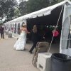 Bride and groom entering recpetion under 30' x 90' frame tent