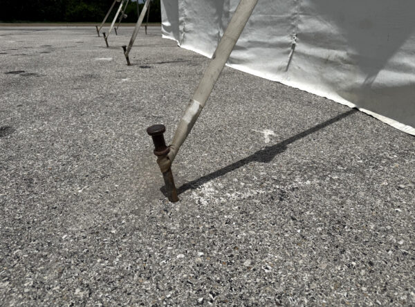 Drill and Fill Tent Stake in pavement or asphalt (close-up)