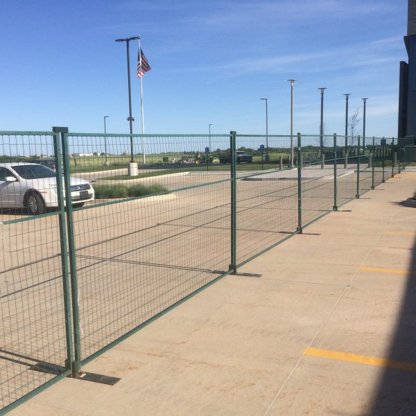 Green temporary security fencing. Event perimeter barricade