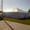 Outside of 30' x 30' frame tent with water barrels