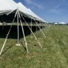 The corner of the 80′ x 120′ Rope and Pole Tent with gang tent stake bar (plate) with tent stakes and two 20′ x 60′ frame tents (right) at North Liberty Blues & BBQ at Centennial Park in 2026
