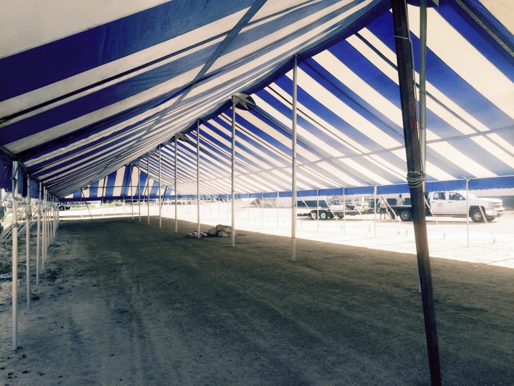 Under the 40' x 160' Gala rope and pole tent with poles