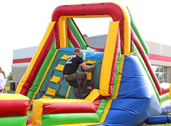 Hard climb up the rope ladder section of the inflatable obstacle course challenge.