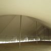 60' x 150' rope and pole tent with sidewalls in the process of being attached.