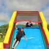 Enjoying the slide down the inflatable obstacle course challenge.