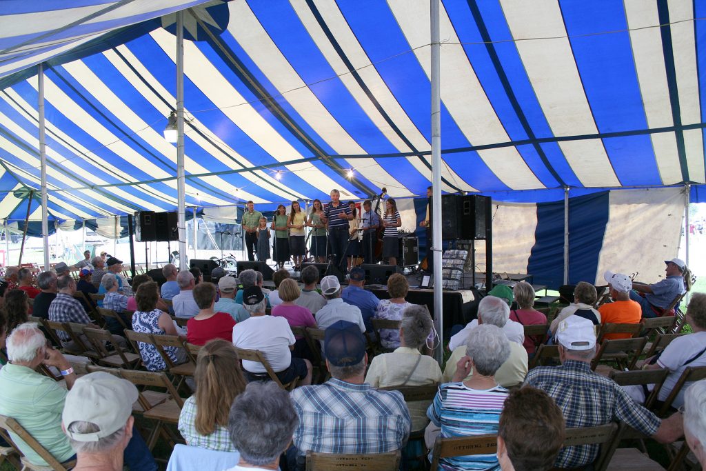 Stage under 40' x 100' blue and white rope and pole tent