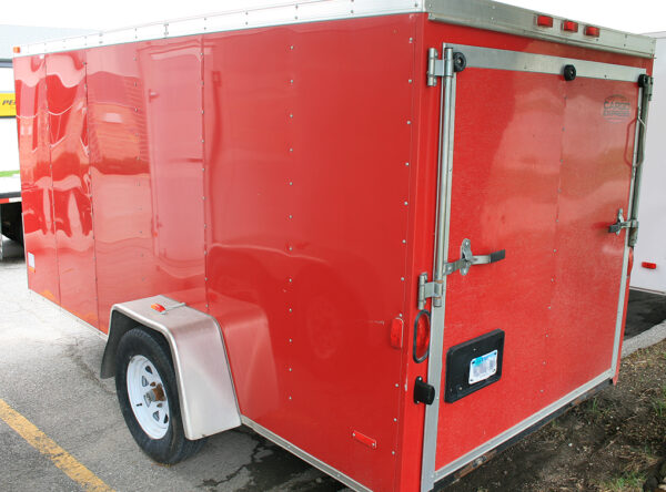 Back of our Orange/Red 6'x12' single axel enclosed utility cargo trailer for rent.
