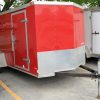 Orange/Red 6'x12' single axel enclosed utility cargo trailer for rent.