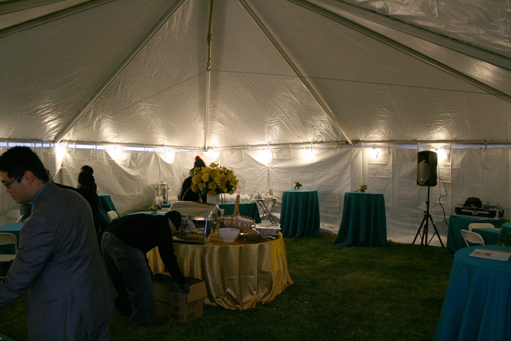 Inside heated tent with lights and power outlets for event.