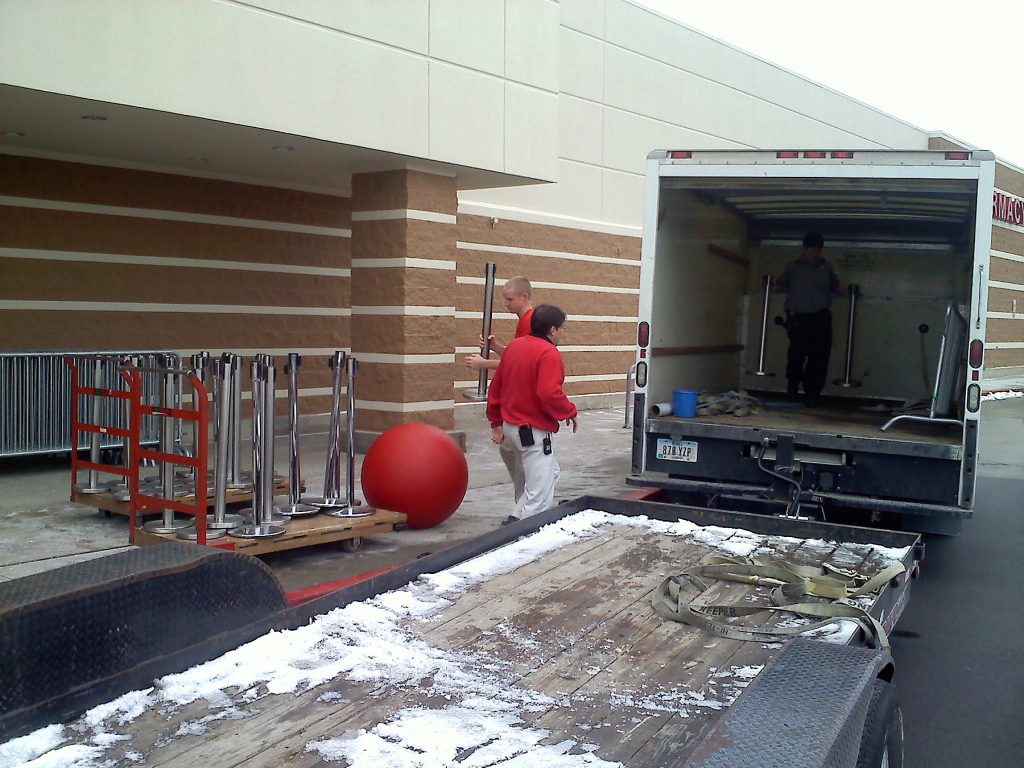 Last delivery of belt style stanchions for crowd control at Target for Black Friday.
