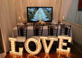 Wedding Booth with flowers and lighting