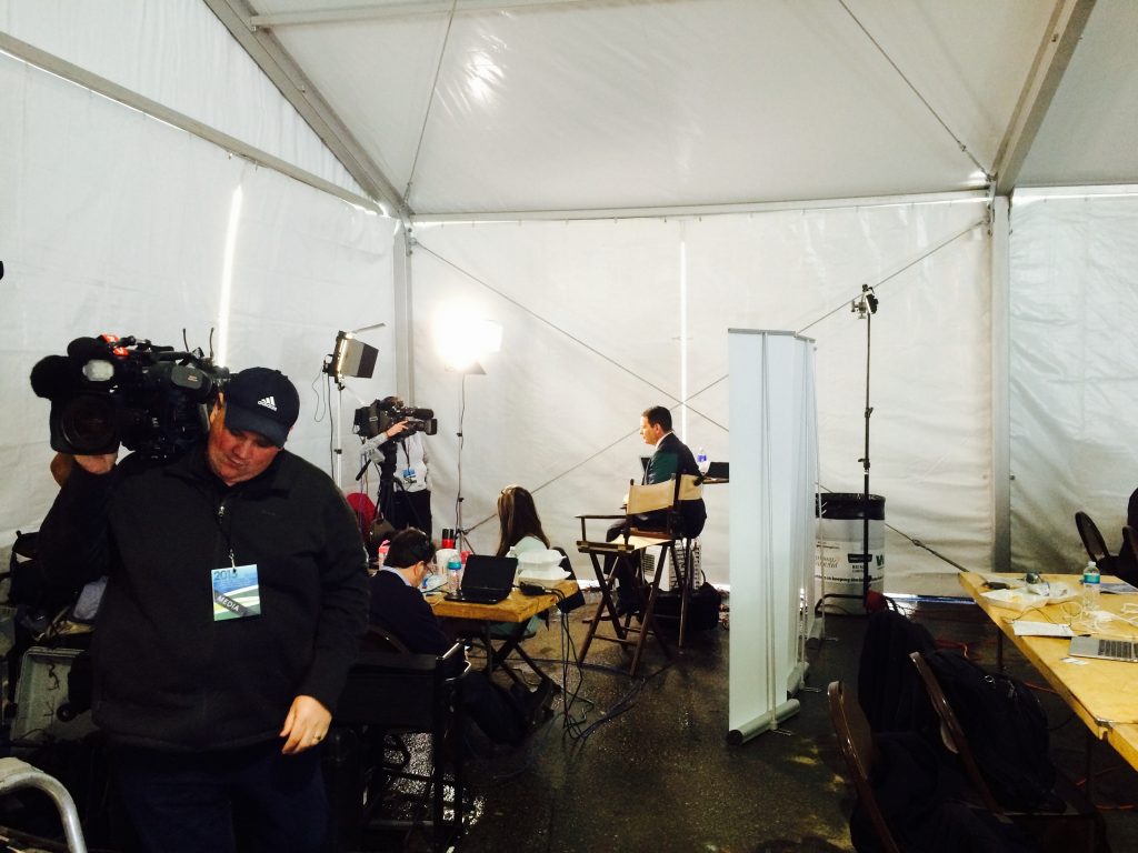 Reporters setup under clearspan tent at 2015 Iowa Ag Summit