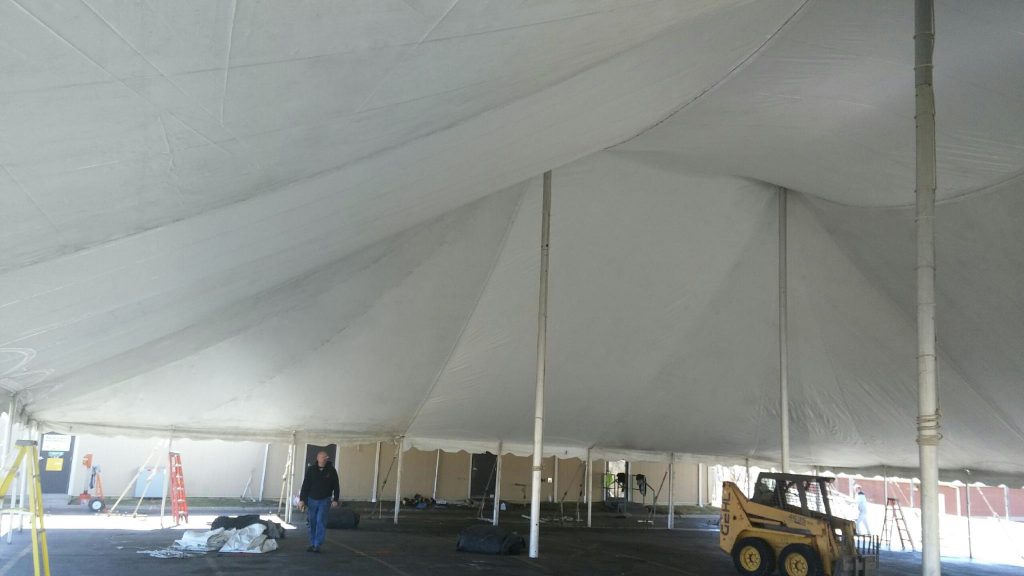 Under the twin pole rope and pole event tent