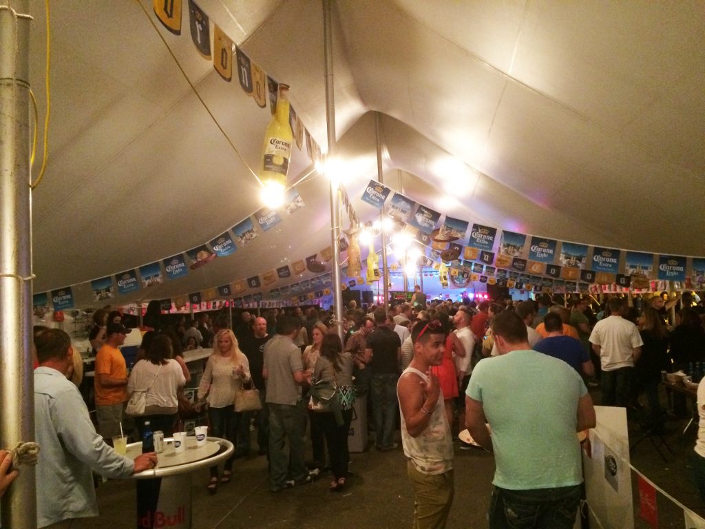 Crowd of people at Gonzos under 40' x 140' rope and pole tent