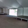 Under 40' x 140' rope and pole tent at restaurant for Cinco de Mayo with stages