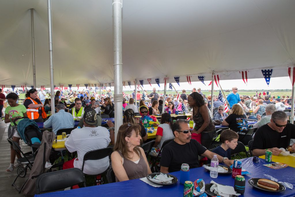 Crowd of people eating under tent at Quad City Airshow QCAS 2015