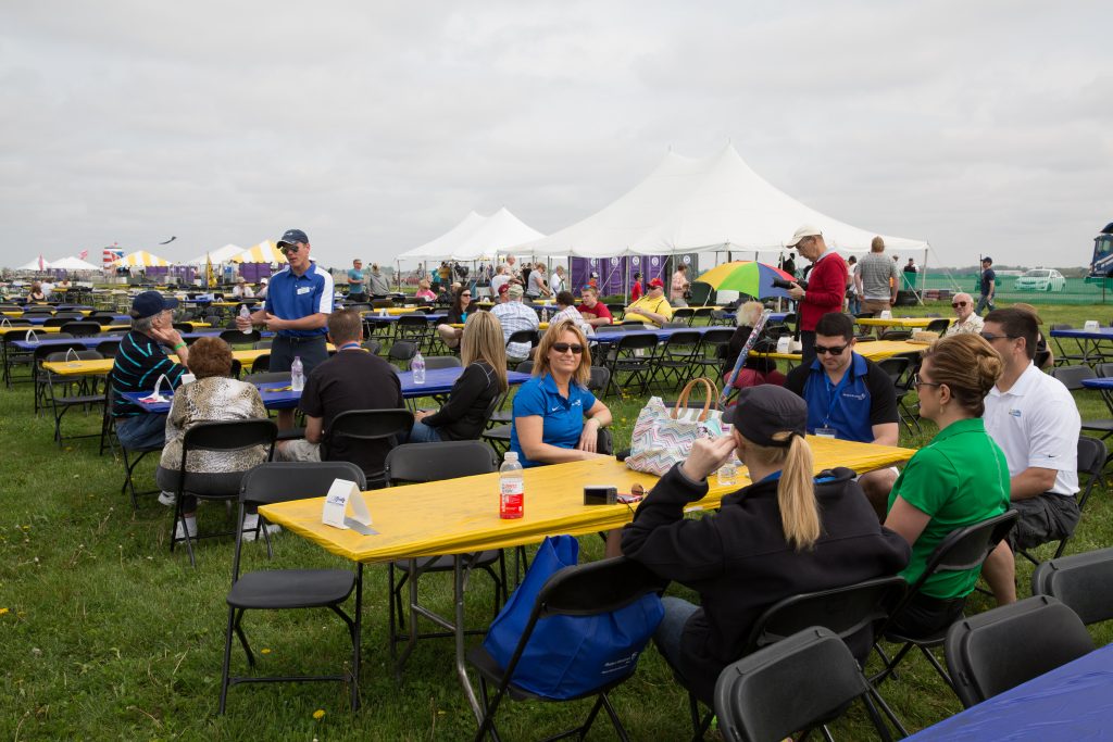 Seated crowd at tables at Quad City Airshow QCAS 2015