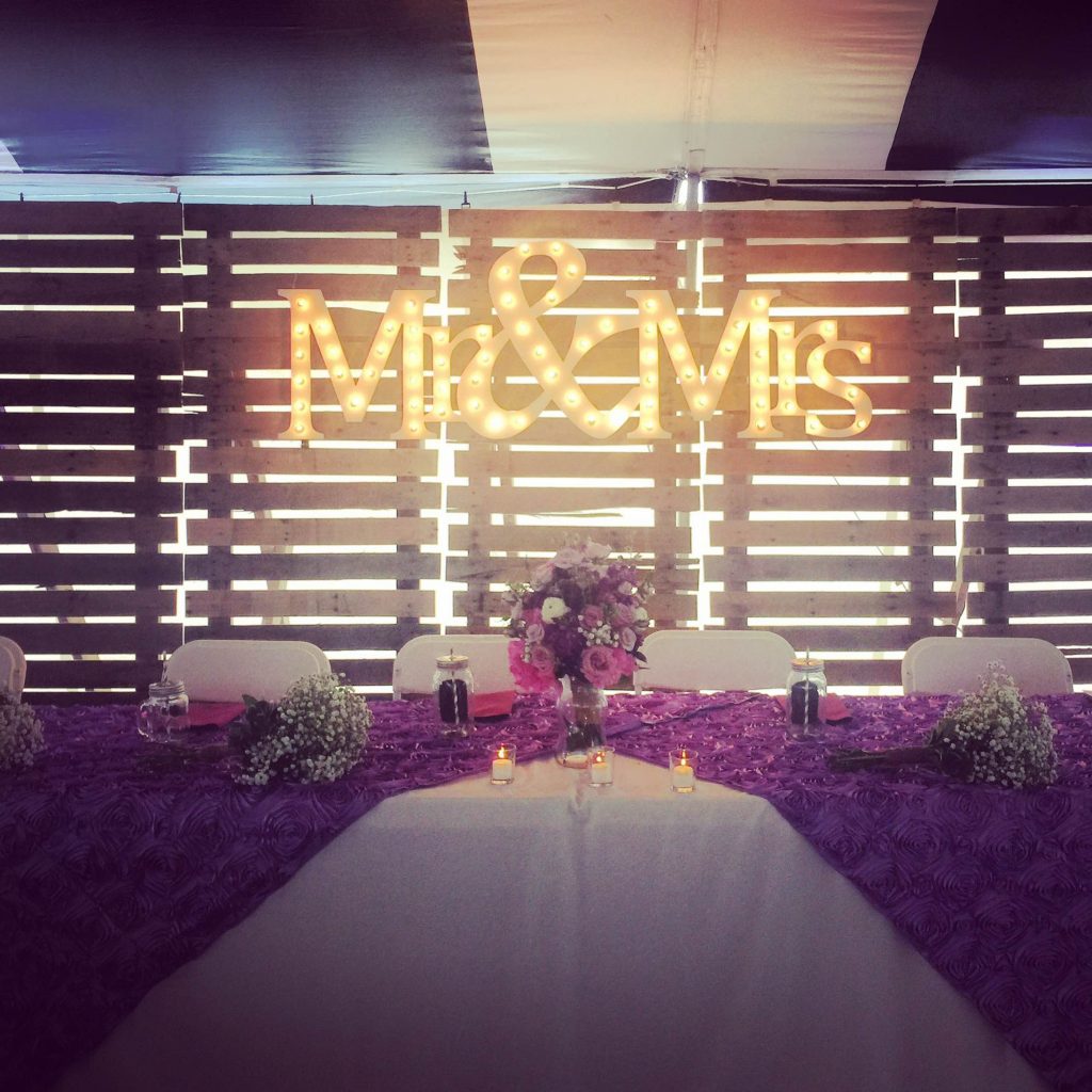 Head table with backdrop at wedding
