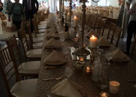 Wedding reception tables setup under clearspan tent