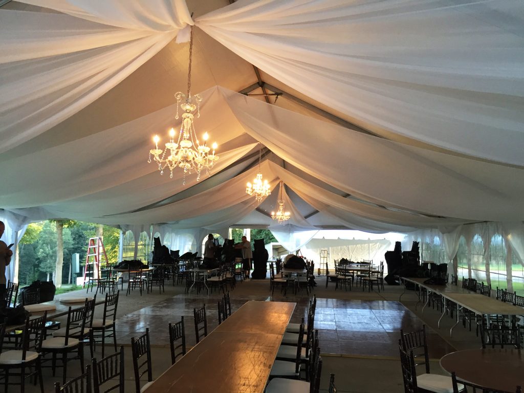 40' x 80' wedding tent with chandeliers and sheer drape install picture