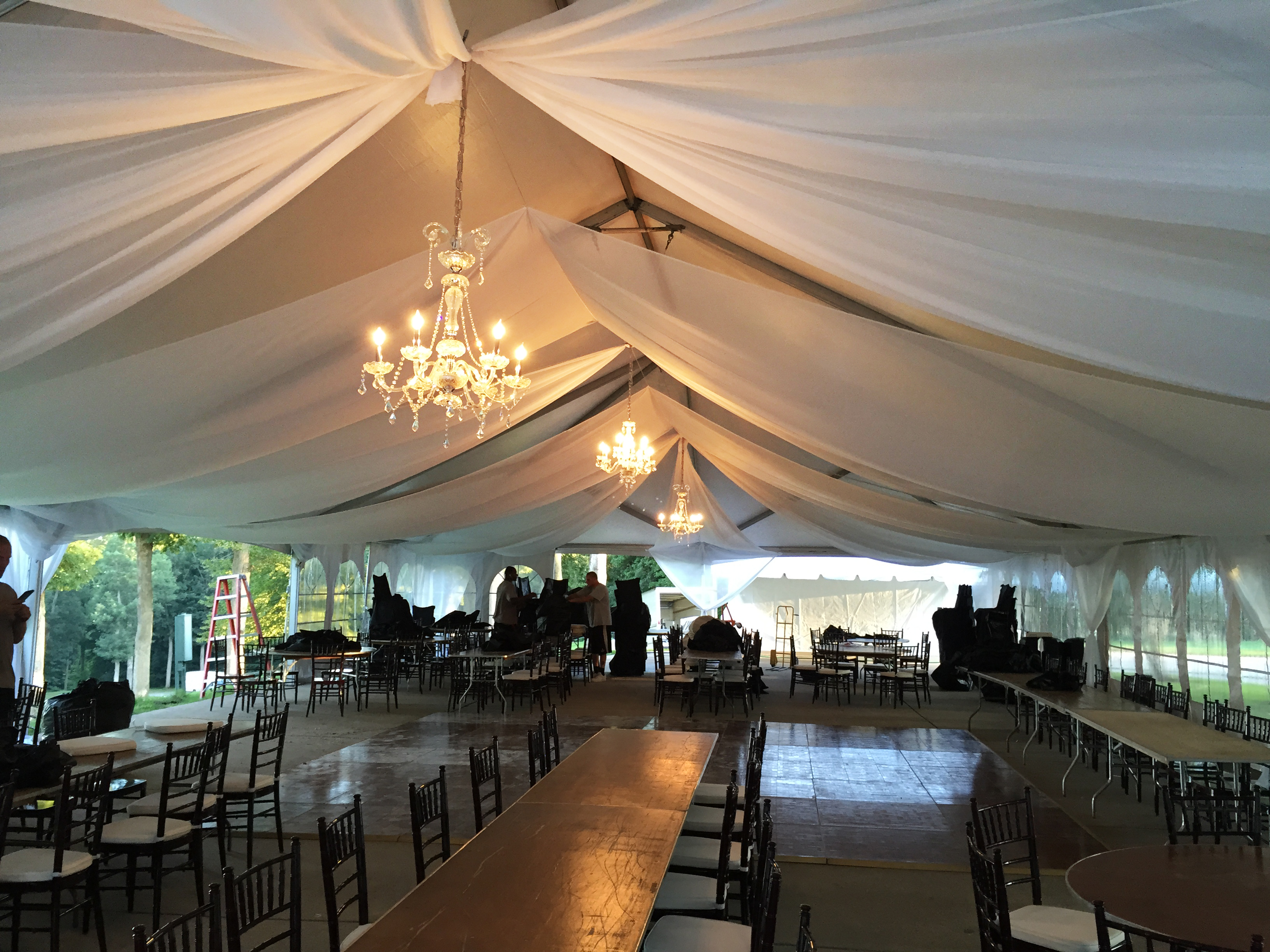 Wedding tent with chandeliers and sheer draping in Illinois