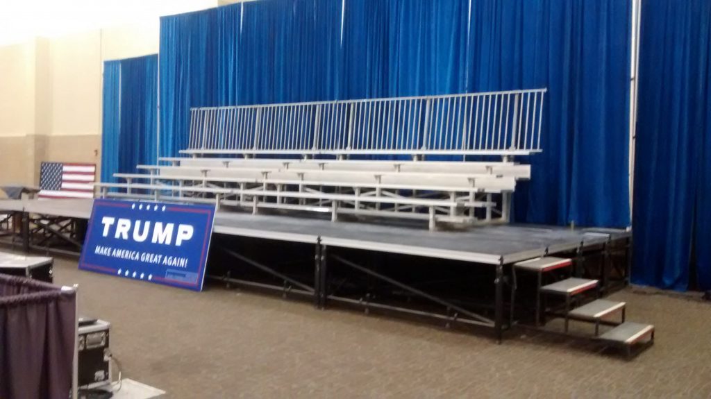 Elevated bleachers two 5-row bleachers side by side pipe and drape at Trump political event in Dubuque, Iowa
