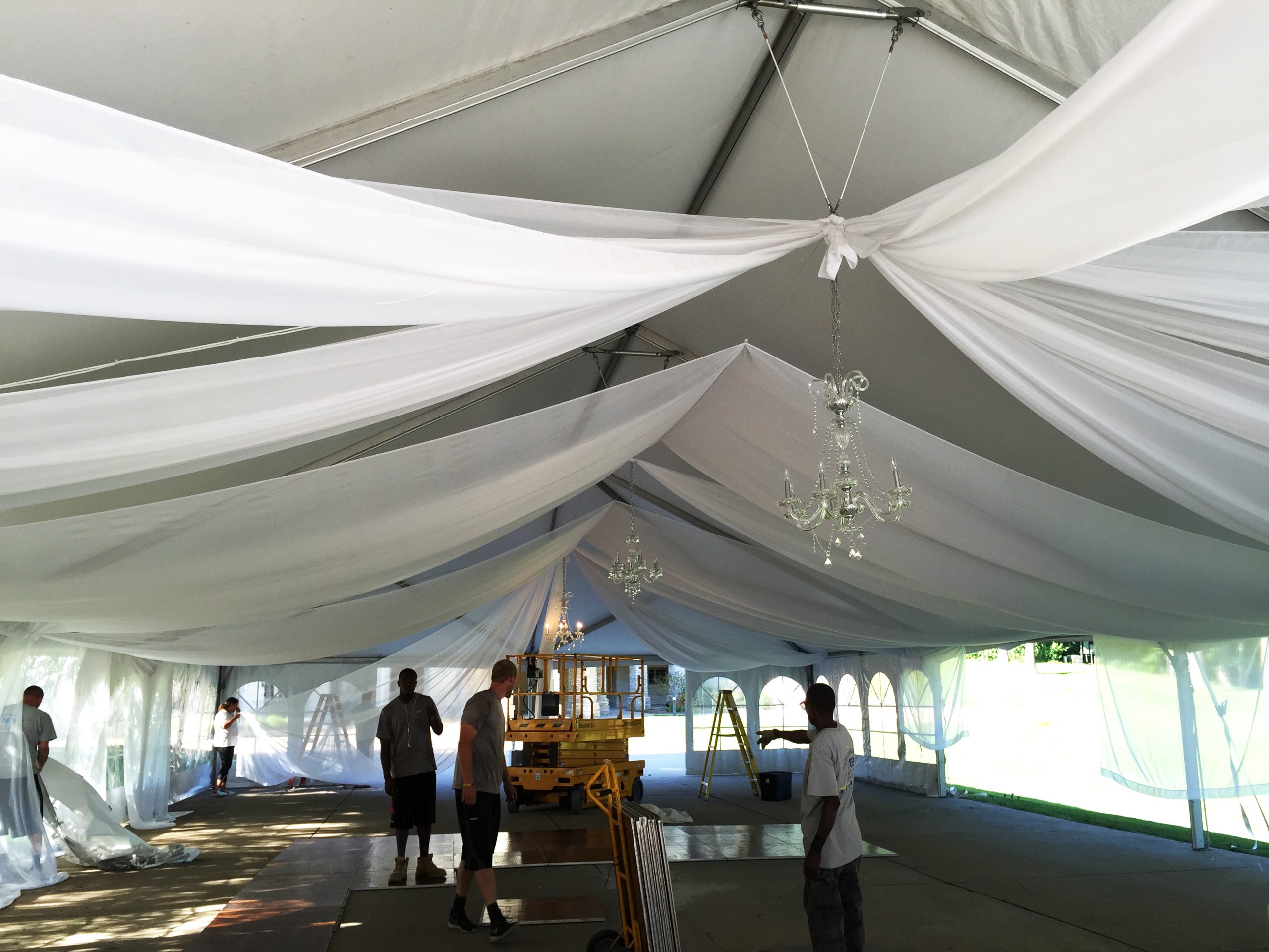 Installation of sheer drape under 40′ x 80′ Hybrid wedding tent