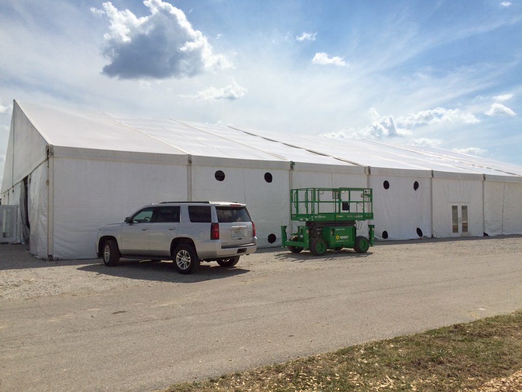 Outside of 100' x 131' clear span tent with holes for A/C units