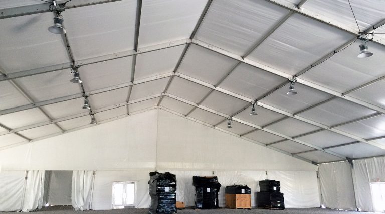 Under 100' x 131' clear span tent with high-bay lighting