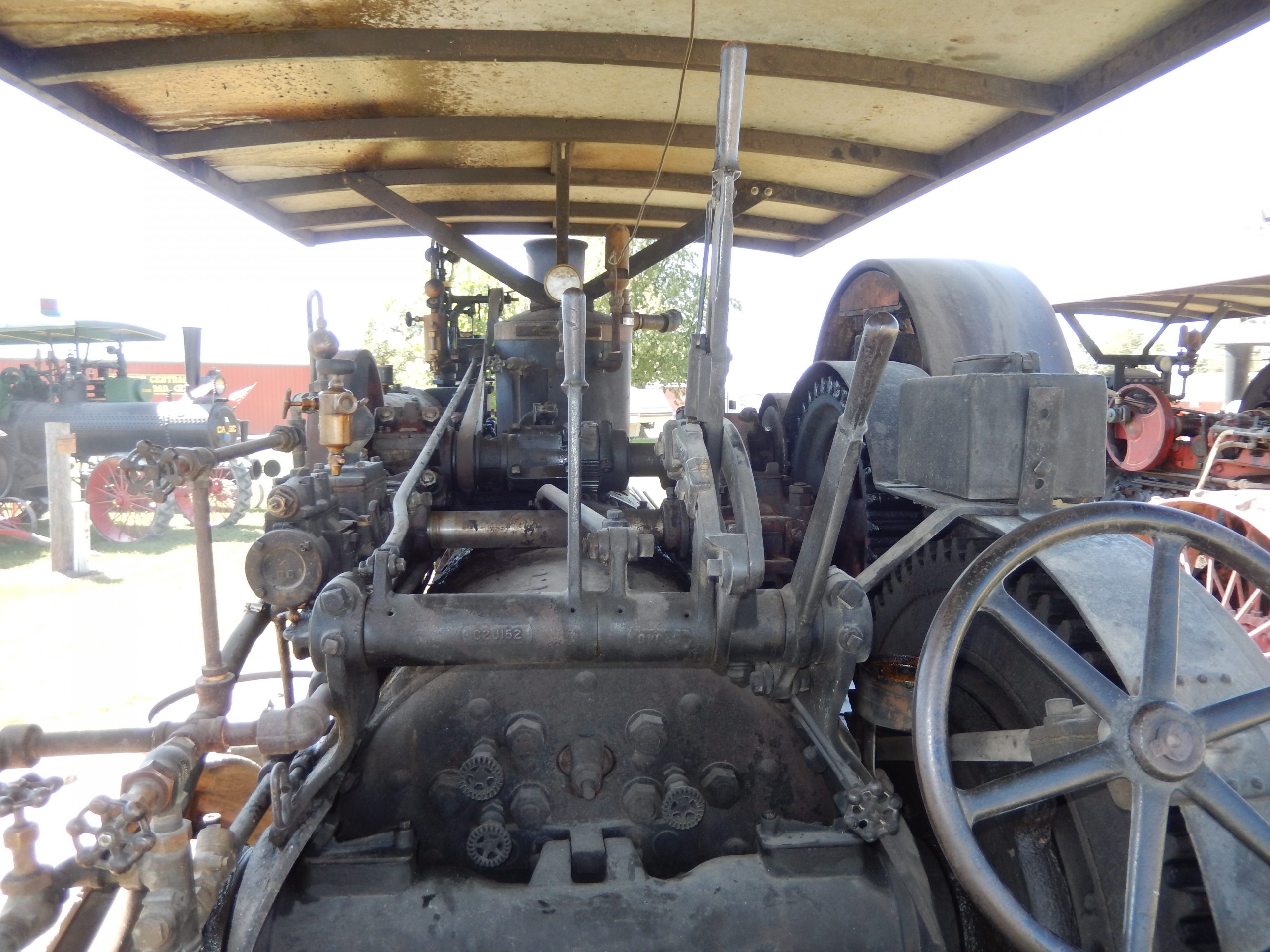 View from behind and old steam engine tractor