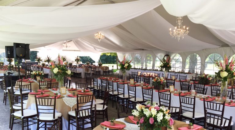 Wedding tent with chandeliers and sheer draping in Illinois