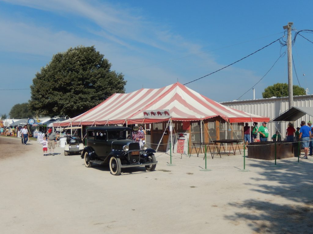 30' x 60' Red & white (rope and pole) tent used for food service