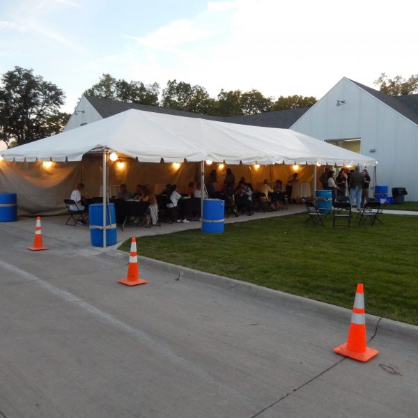 20' x 50' frame tent with tables, lights, linens and chairs