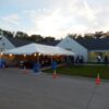 20' x 50' frame tent with tables, lights, linens and chairs at Pet Adoption Center