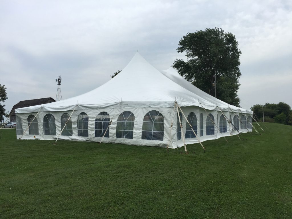 3/4 view of backyard wedding reception under a tent