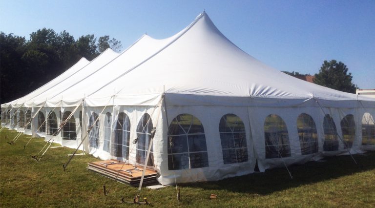 Wedding reception tent for about 160 guests with dance flooring and lighting
