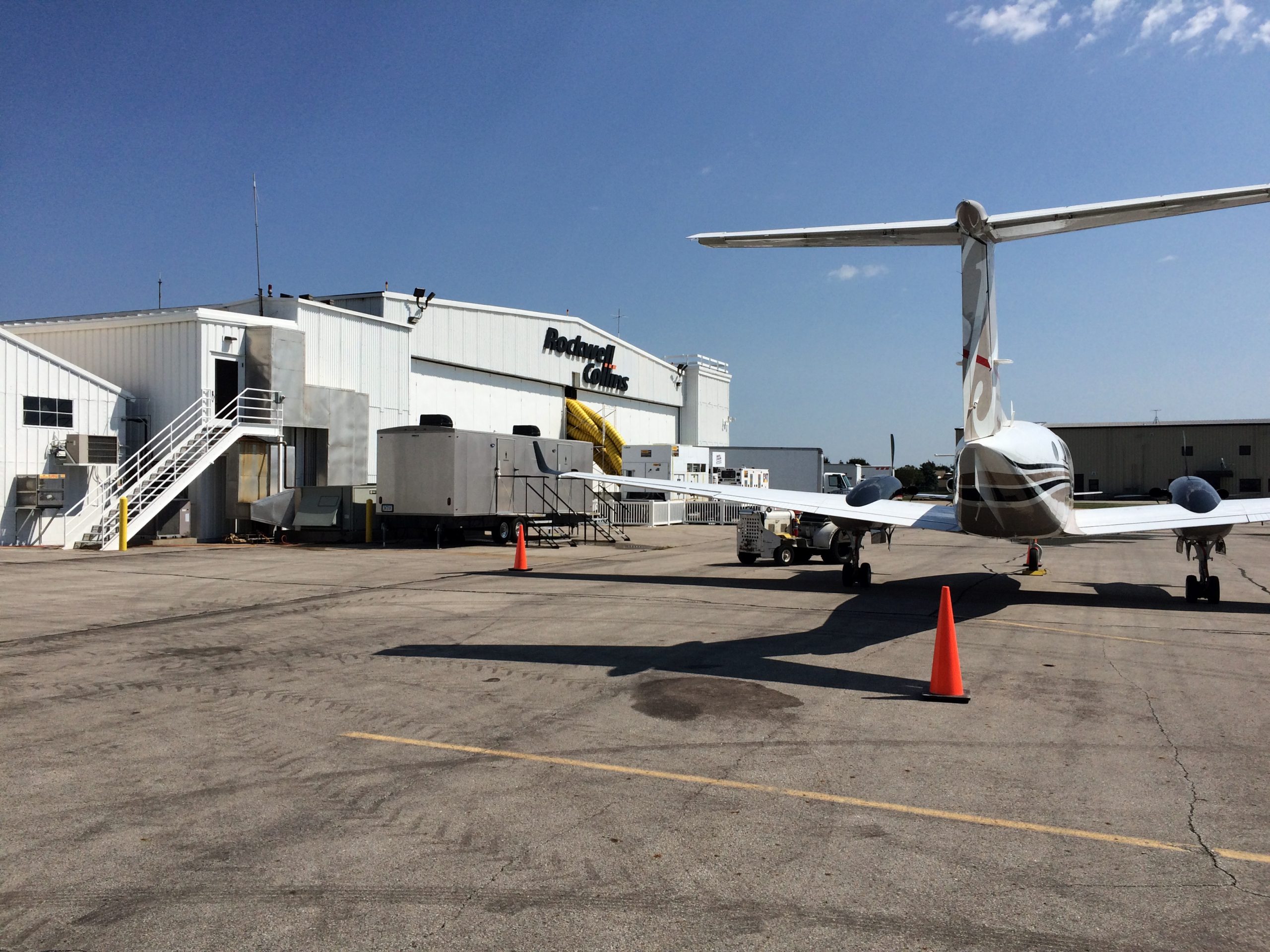 Airplane, Generator and Air Conditioning units outside of airplane hangar