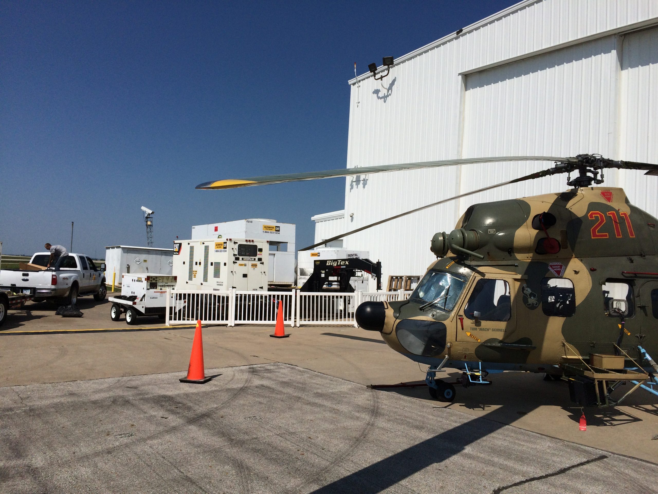 Helicopter, Generator and Air Conditioning units outside of airplane hangar