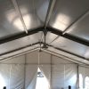 Multiple ceiling fans installed on Losberger clearspan event tent at the roof peak